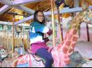 Ella taking a ride at the Gardens