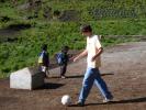 Josh playing soccer with the school children