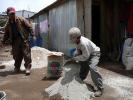 Antonio and son mixing mortar for the 4th stove