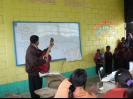 Upper Grade teacher leading singing with his class