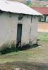 Little girl looking out of her house