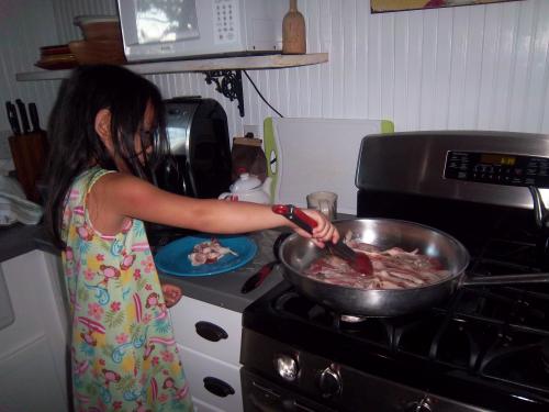 Ella making breakfast for everyone.