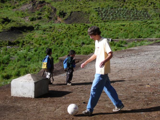 Josh playing soccer with the school children
