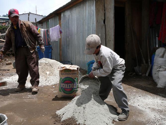 Antonio and son mixing mortar for the 4th stove