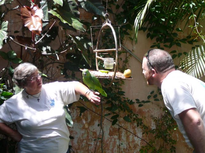 Gail and Kevin with Lorenzo the parrot