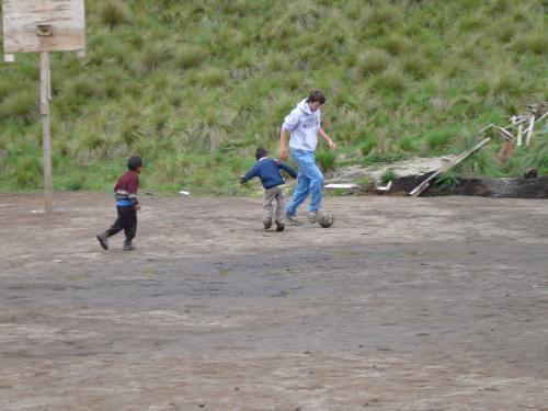 Josh playing soccer with school children