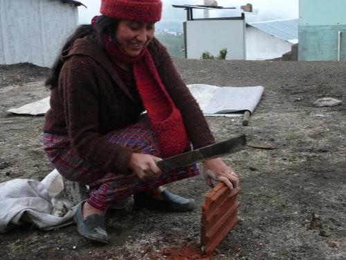 Hilda shaping the red piece that goes above the stove door