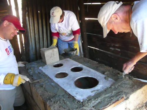 Theresa, Wayne and Dave working on our 4th and last stove