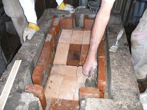 Adding fire brick to the top of the sand level