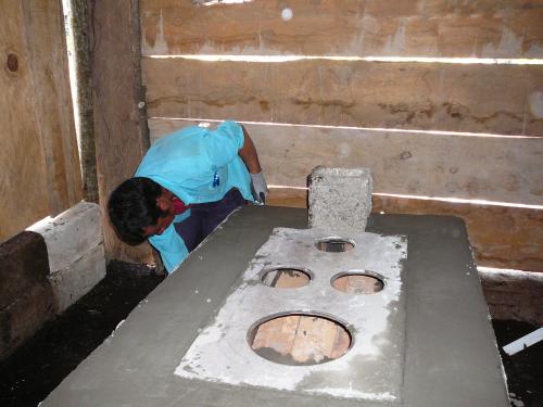 Owner working on stucco for his stove