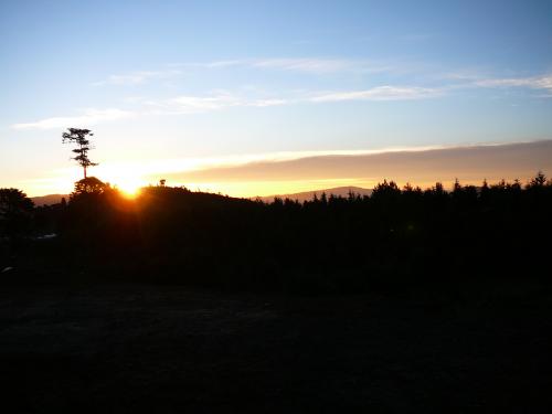 Sun peeking over the hill at Xolja