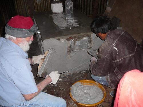 Father helping to put on the stucco
