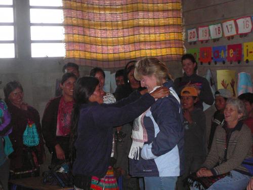 A family giving a gift to Kim W.