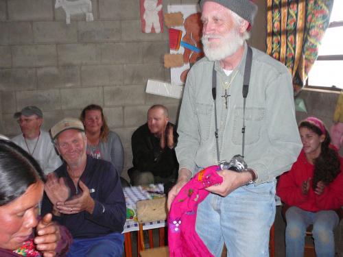 Bill receiving a gift from a family