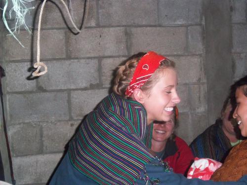 Shannon receiving her weaving from the women